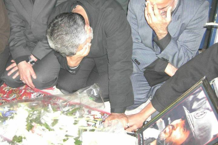 Martyr Haj Qasem Soleimani next to the tomb of Martyr Haj Ahmad Kazemi